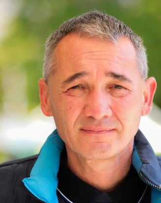 a man wearing a blue jacket and a black shirt